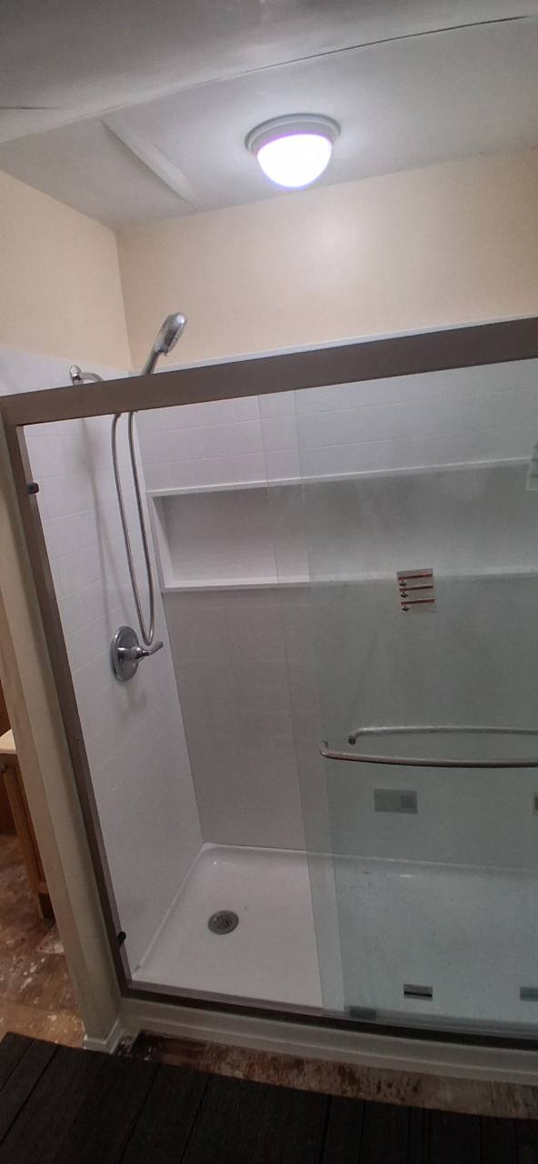 After: walk-in shower with sliding glass doors
