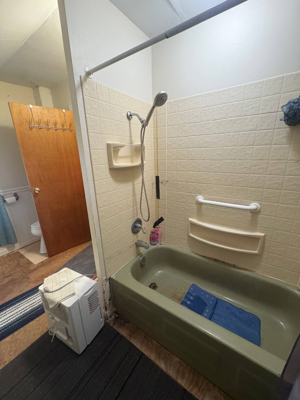 Before: original bathtub and tiled bathroom surround